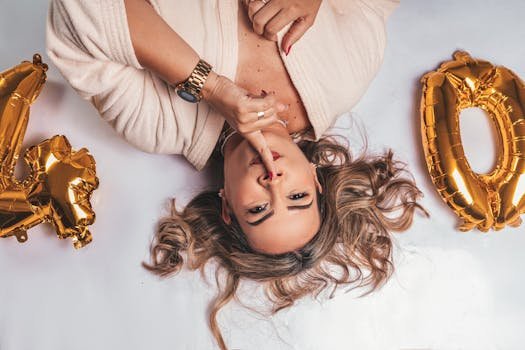 Elegant woman celebrating her 40th birthday with golden balloons in a stylish setting.